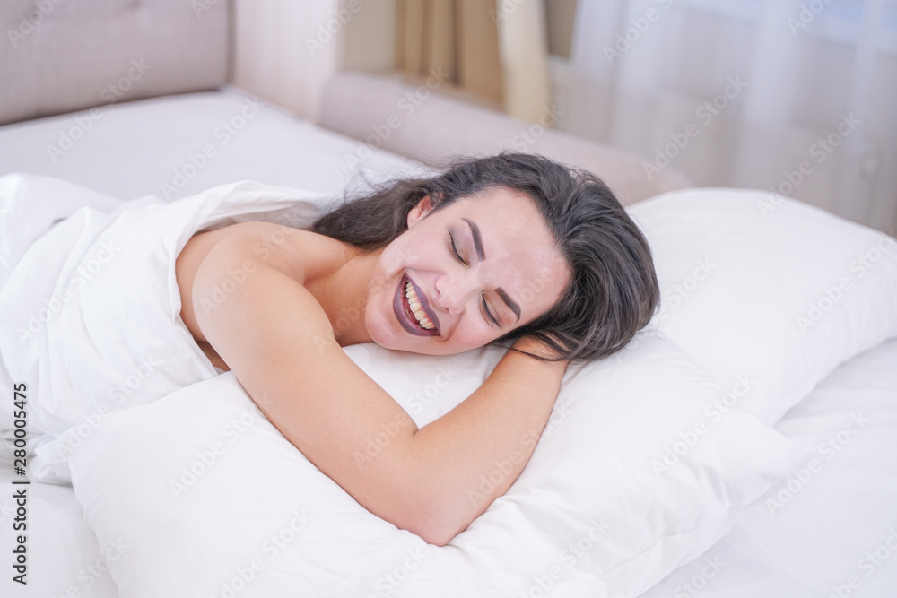 charming young brunette girl resting in her white bed charming young brunette girl resting in her white bed