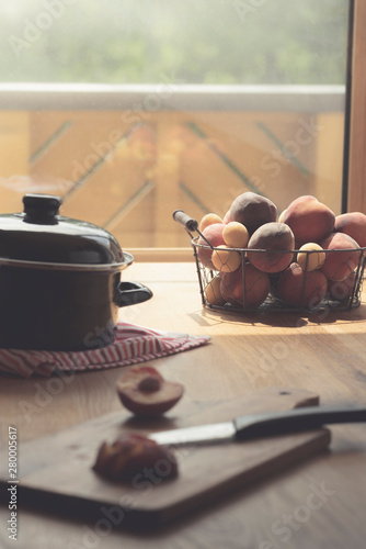 Fruits basket on wooden table in natural light photo