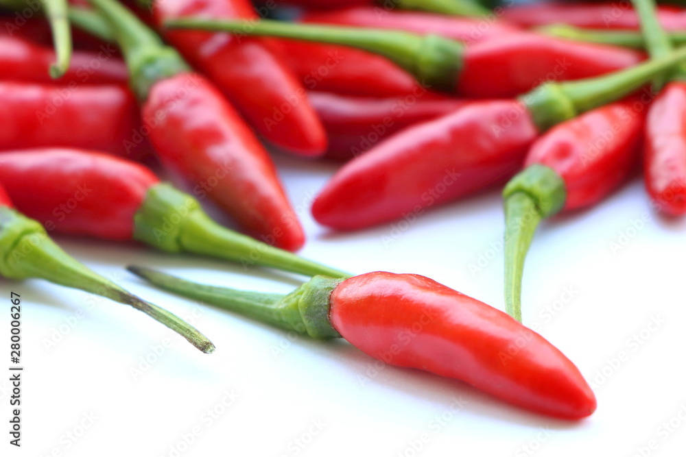 close up red chillies pile on white background