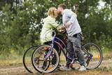 Sideways couple kissing on bicycles