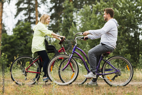 Sideways happy couple on bicycles
