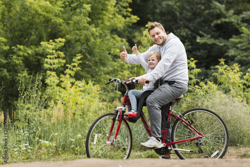 Happy father and daughter on bike