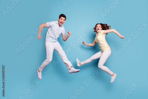 Full length body size view of nice-looking attractive lovely playful childish carefree cheerful cheery people having fun fooling rejoicing isolated over bright vivid shine blue green background