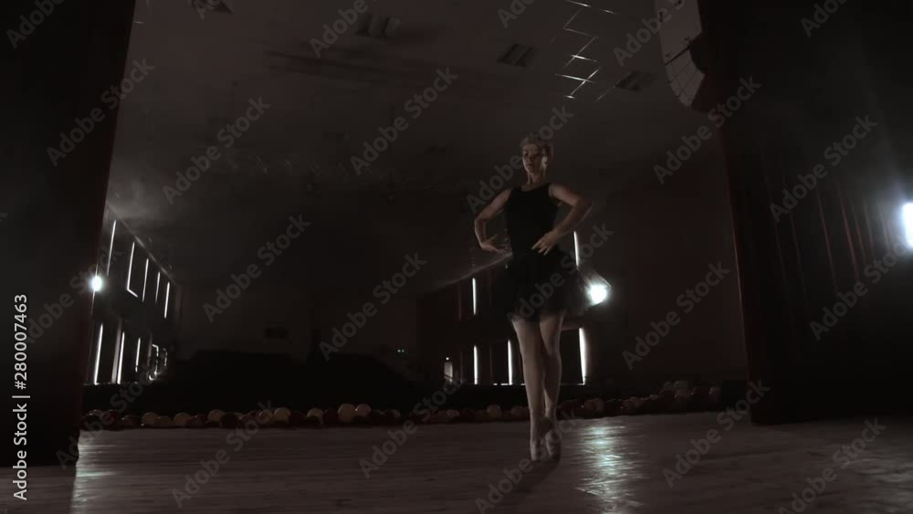SLOW MOTION. unrecognizable beautiful ballerina performing on dark smoke stage. Blonde woman with hair in black. Ballet dress dancing with hands. SLOW MOTION. unrecognizable beautiful ballerina performing on dark smoke stage. Blonde woman with hair in black. Ballet dress dancing with hands.