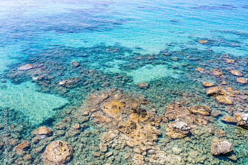 Aerial view of beautiful rocky coastline with turquoise sea water..