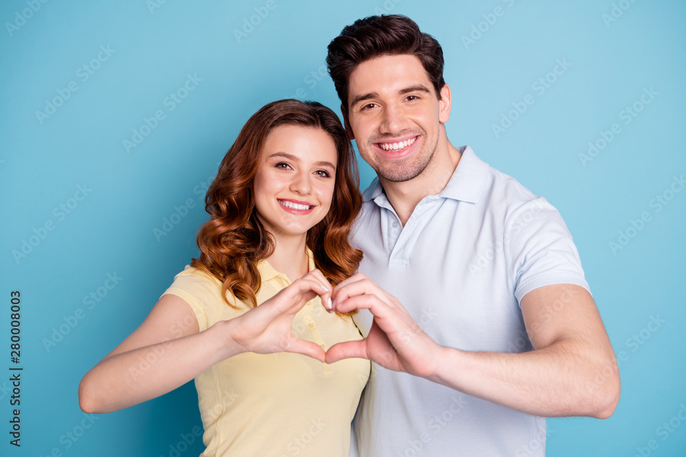 Portrait of his he her she nice-looking attractive cheerful cheery married spouses wearing casual showing heart isolated over bright vivid shine blue green background Portrait of his he her she nice-looking attractive cheerful cheery married spouses wearing casual showing heart isolated over bright vivid shine blue green background