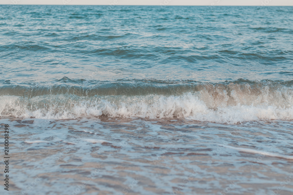 Waves on the sea, ocean. View of the sea from the shore in the afternoon in summer.