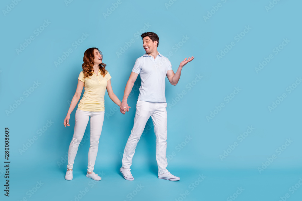 Full length body size view of nice charming attractive lovely cheerful cheery friendly married spouses holding hands sharing stories isolated over bright vivid shine blue green background