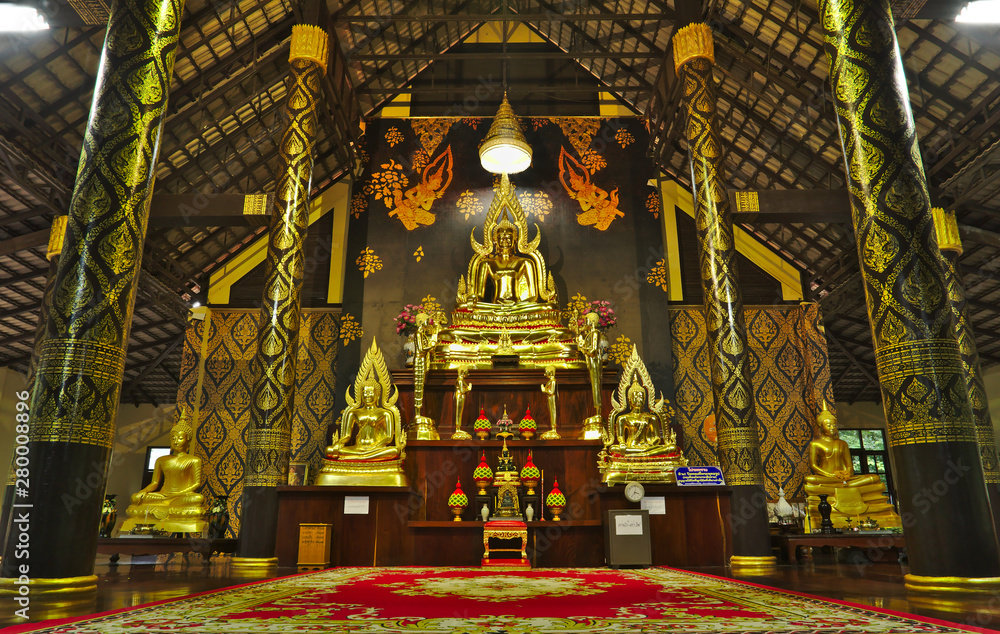 Gold buddha statues inside wooden temple (Wat khao banchob) in Chantaburi Thailand