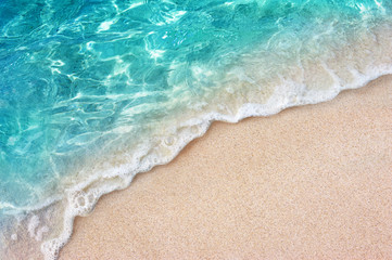Soft blue ocean wave or clear sea on clean sandy beach summer concept