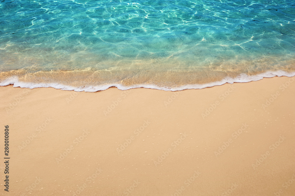 Soft blue ocean wave or clear sea on clean sandy beach summer concept