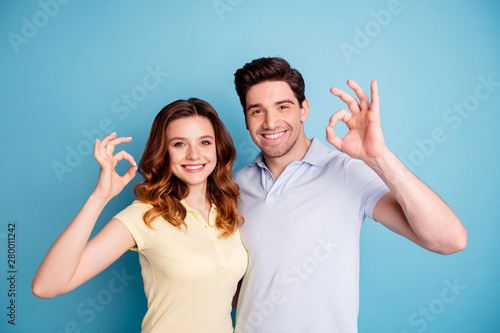 Photo of two pair people okey symbol hands approve best quality tested product wear casual t-shirts isolated blue background