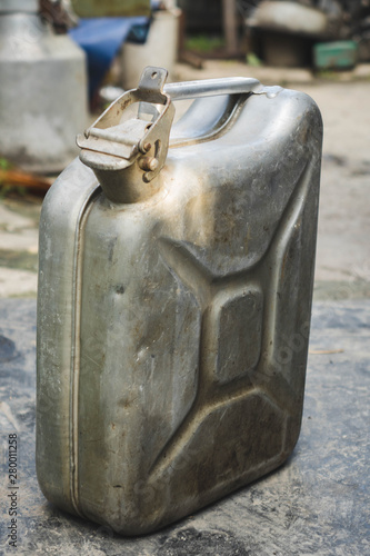 Old metal jerrycan or gasoline canister fuel can. photo