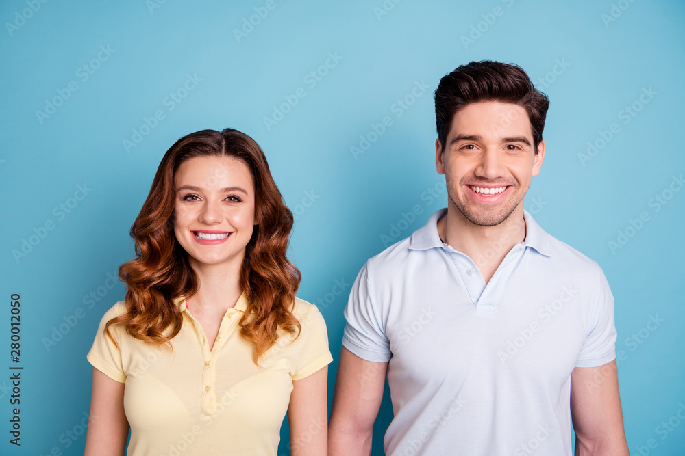 Close up photo of two pair people positive mood lovely look white perfect teeth wear casual t-shirts isolated blue background Close up photo of two pair people positive mood lovely look white perfect teeth wear casual t-shirts isolated blue background