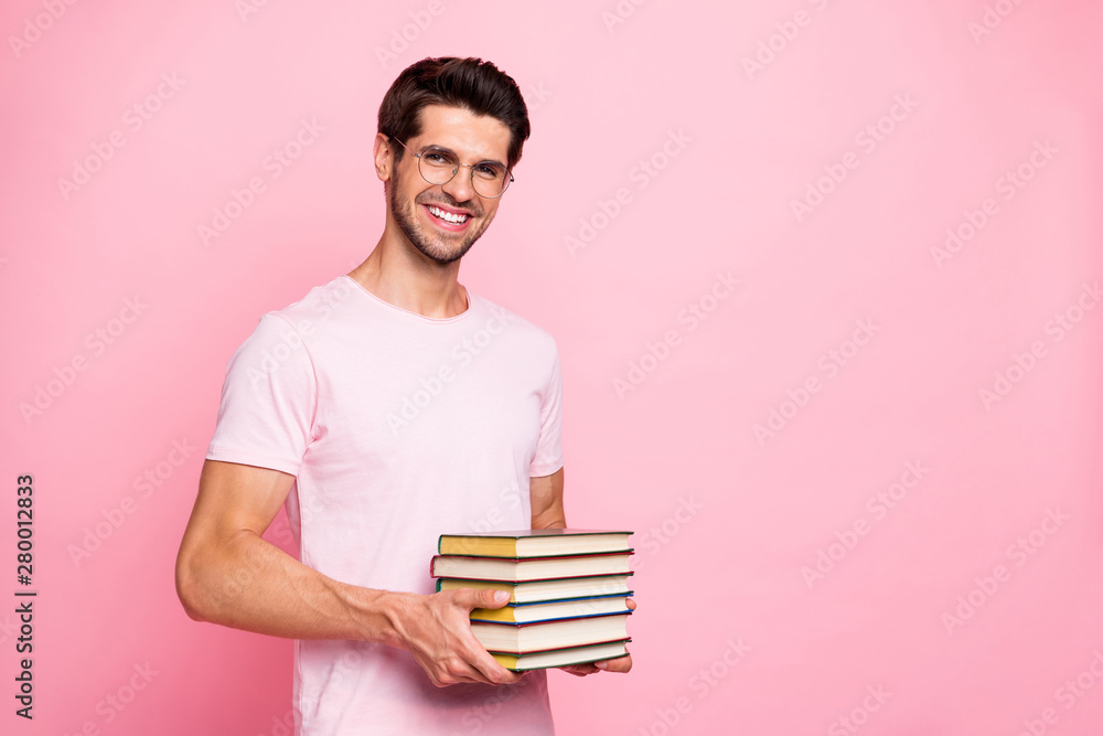 Portrait of his he nice attractive content confident diligent cheerful cheery glad positive intelligent guy holding in hands carrying book library isolated over pink pastel background Portrait of his he nice attractive content confident diligent cheerful cheery glad positive intelligent guy holding in hands carrying book library isolated over pink pastel background