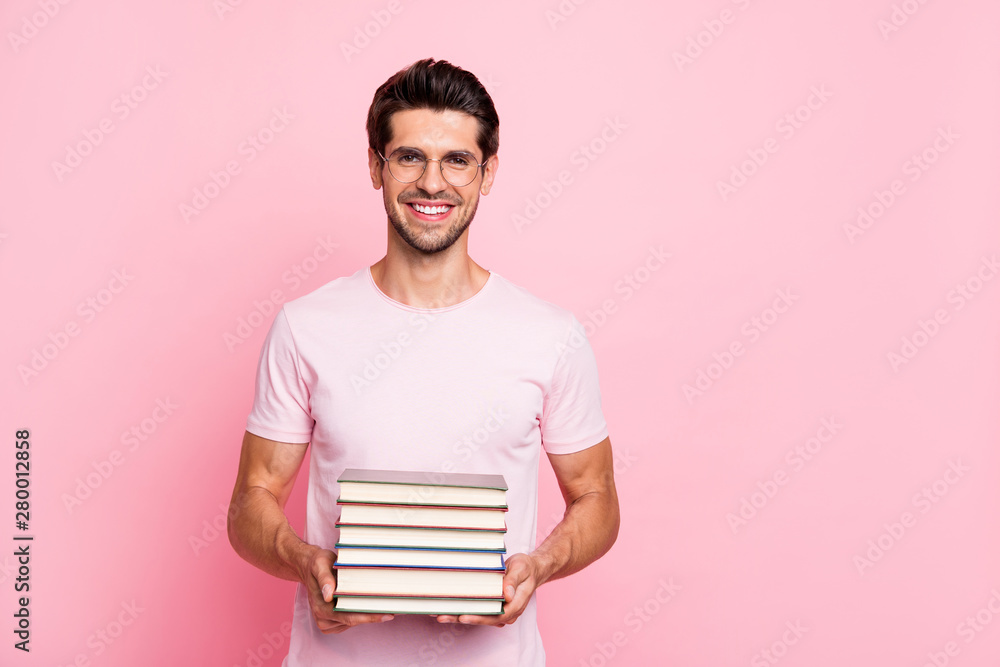 Portrait of his he nice attractive content cheerful cheery intellectual brainy guy keeping holding in hands book isolated over pink pastel background Portrait of his he nice attractive content cheerful cheery intellectual brainy guy keeping holding in hands book isolated over pink pastel background