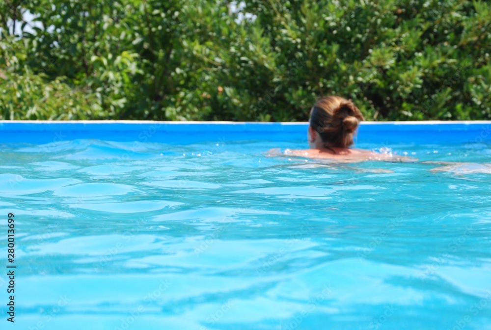Girl Swimming in Pool Portrait