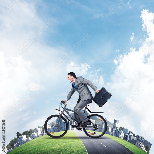 Young man riding bicycle on highway