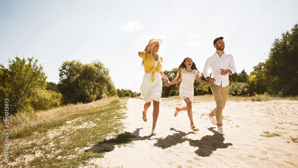 Happy young family spending time together in countryside