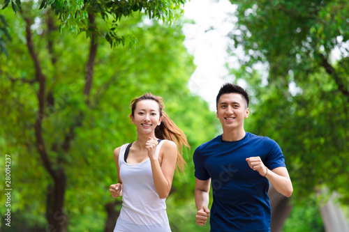happy young Couple jogging and running in park