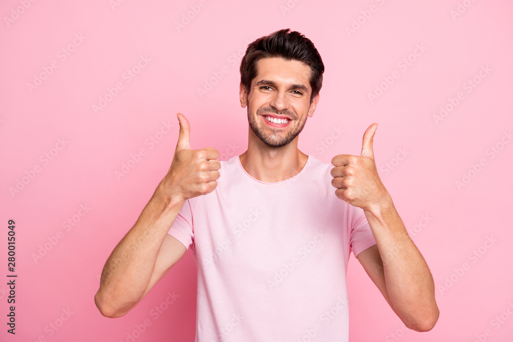 Photo of amazing guy approving tested product by raising thumbs up casual outfit isolated on pink background Photo of amazing guy approving tested product by raising thumbs up casual outfit isolated on pink background