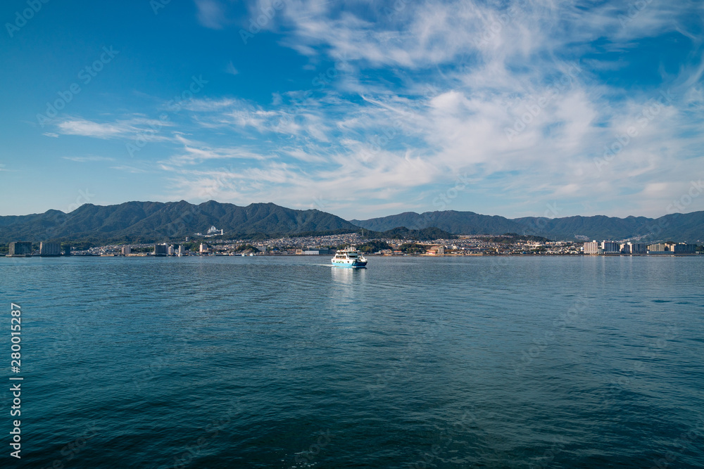 Ferry-boat ride on a beautiful morning in Hiroshima Bay to the island of Miyajima, Japan. Miyajima Island is a Holi Shinto Shrine, listed as an Unesco World Heritage Site. Ferry-boat ride on a beautiful morning in Hiroshima Bay to the island of Miyajima, Japan. Miyajima Island is a Holi Shinto Shrine, listed as an Unesco World Heritage Site.