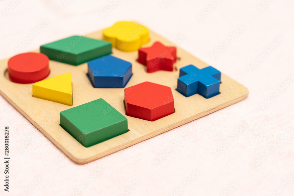 Top view closeup of colorful wooden Montessori sensorial material learning, Shape and color block. Kindergarten educational toys, Thinking process, Cognitive skills, Learn Through Play tools concept.