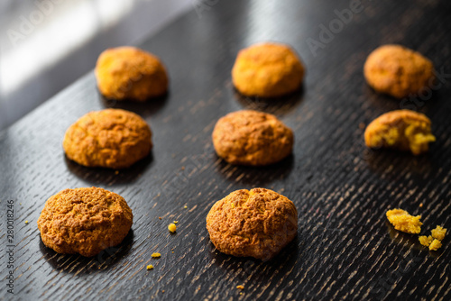 homemade carrot scones on a dark wooden backdrop, dark style
