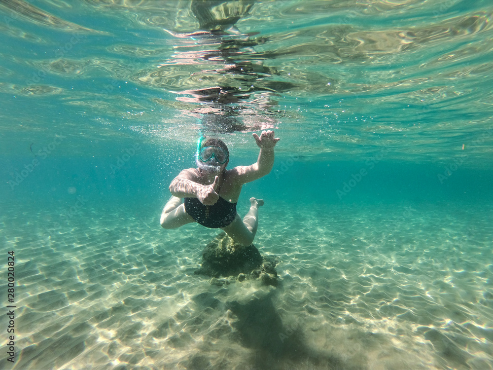 Diving in the sea water. Underwater walking at the bottom of the seash.