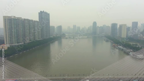 Bridge in Guangzhou in Smog, Car Traffic and Cityscape. Guangdong, China. Aerial View. Drone Flies Backwards photo