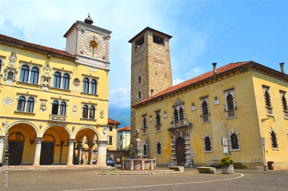 historical part of the old town square with a tower and a building with a dial