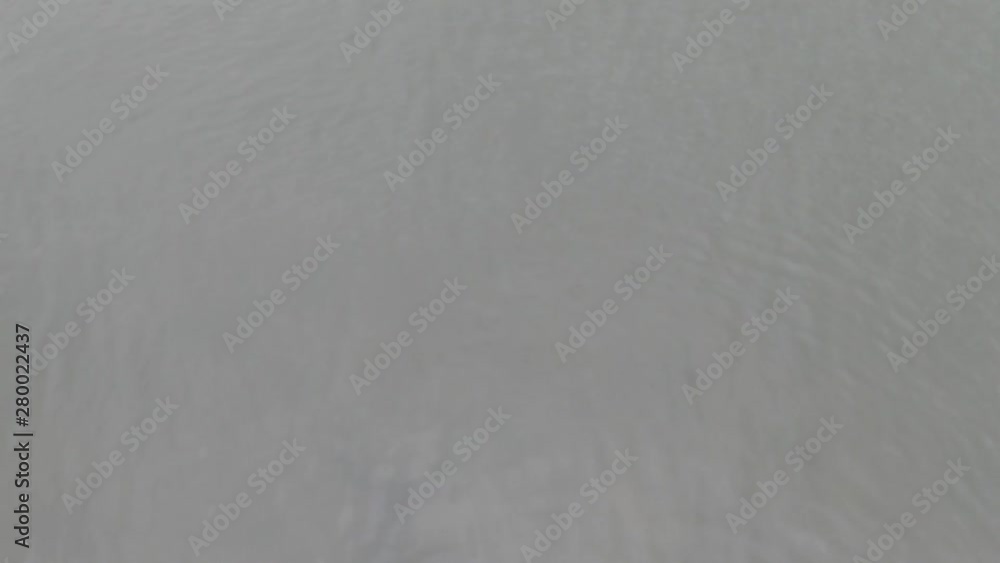 Flying over water. Arial drone shot of sea, waves, coast and forest. Flying over lake and river. Flying over water. Arial drone shot of sea, waves, coast and forest. Flying over lake and river.