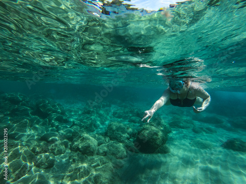 Diving in the sea water. Underwater walking at the bottom of the seash.