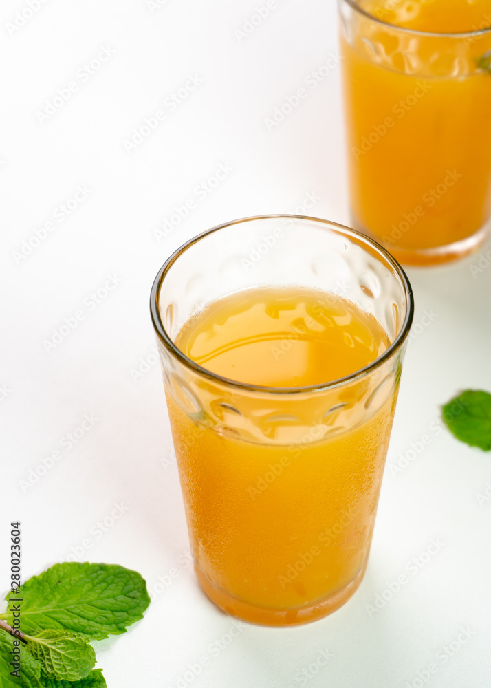 Tasty Orange and grapefruit juice in two glass with mint Tasty Orange and grapefruit juice in two glass with mint