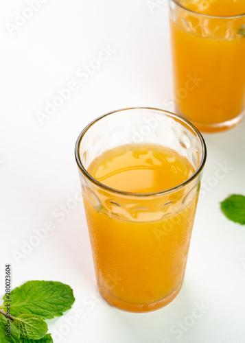 Tasty Orange and grapefruit juice in two glass with mint