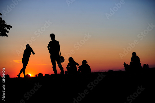 BELGRADE  SERBIA - AUGUST 18  2015  Silhouettes of young people during sunset in Kalemedan park at fortress in Belgrade  Serbia