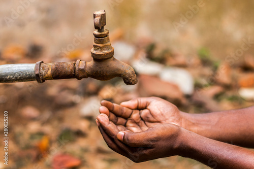 water crisis is a serious threat to India and worldwide a man holding his hand under the tap for water