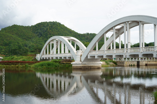 reflection of The Tha Chomphu Railway Bridge or White Bridge