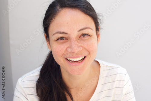 Close up happy young asian woman laughing