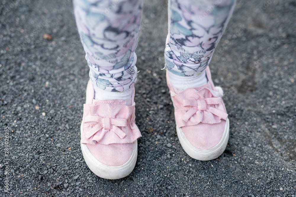 children's feet in colored leggings and moccasins