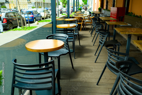 modern plastic black chairs and tables in the cafe, outdoor terrace © Andrey