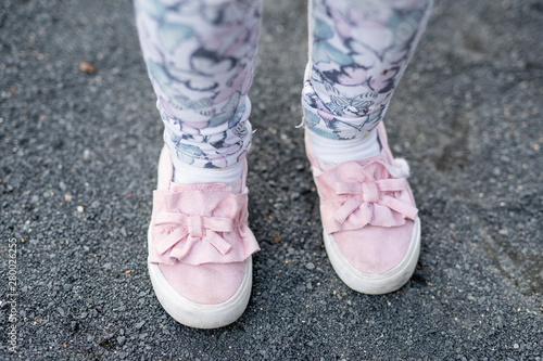 children s feet in colored leggings and moccasins