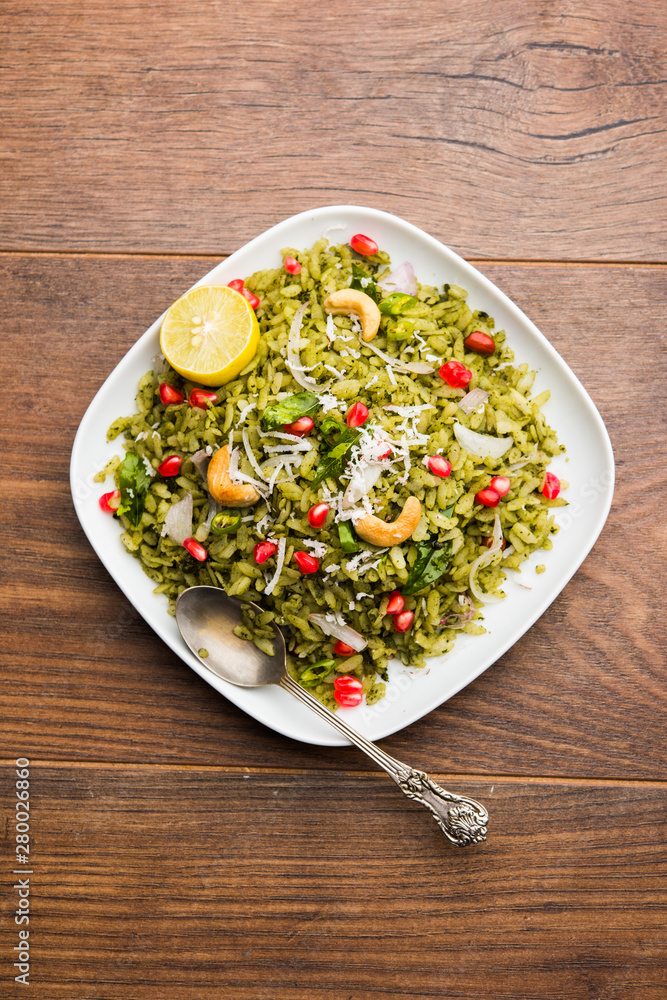 Hariyali Poha / Green Masala Pohe or flattened rice served in a bowl, selective focus Hariyali Poha / Green Masala Pohe or flattened rice served in a bowl, selective focus