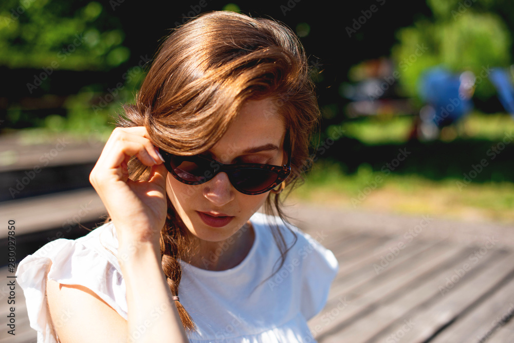Young woman with sunglasses in the Park Young woman with sunglasses in the Park