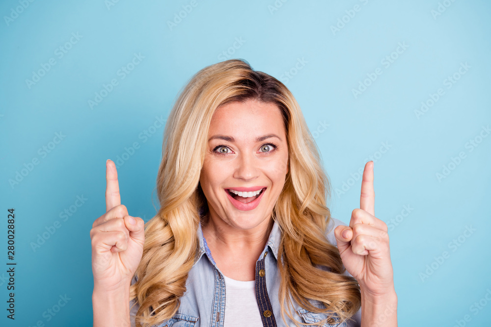 Close up photo of cheerful lady screaming shouting showing ads isolated over blue background Close up photo of cheerful lady screaming shouting showing ads isolated over blue background