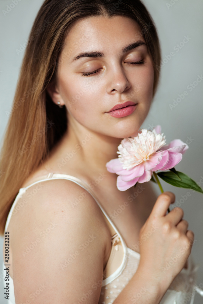 Beautiful lady holding peony flower