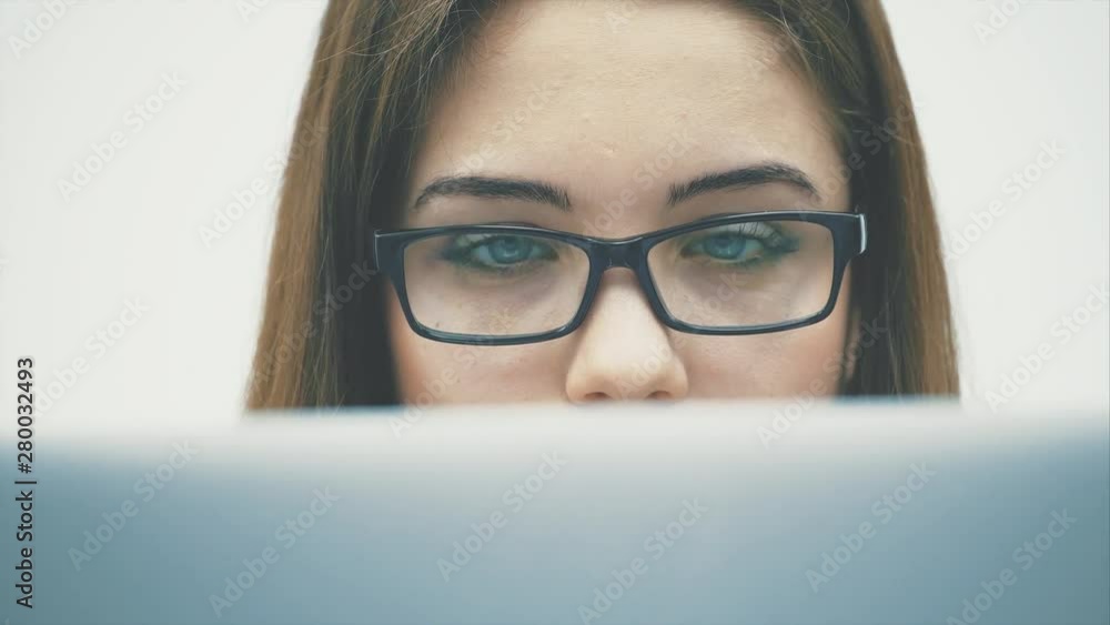 A beautiful young businesswoman working with a document in a tablet. Slow motions. A beautiful young businesswoman working with a document in a tablet. Slow motions.