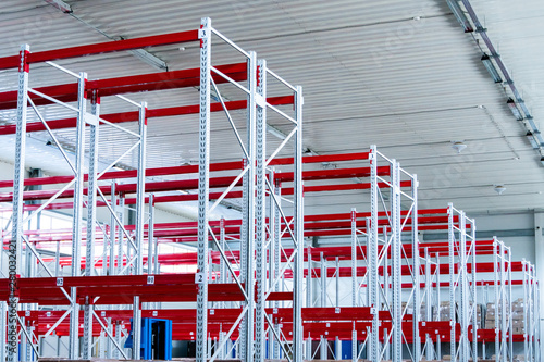 row of mpty warehouse racks, Empty metal shelf in storage room photo