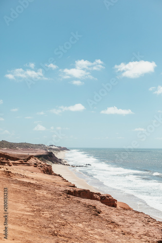 paradise beach without people with hills and palm trees