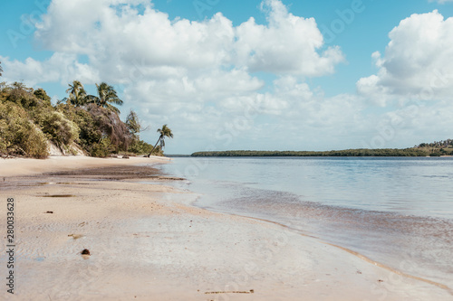 paradise beach without people with hills and palm trees